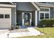 Inviting entrance with a decorative front door, potted plants, and well-manicured landscaping, enhancing curb appeal at 125 Mansfield Blvd, North Charleston, SC 29418