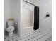 This neutral bathroom has a toilet and shower with a curtain at 132 Heather Dr, Summerville, SC 29486