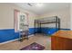 This bedroom features a bunkbed, a desk, and a blue painted accent wall at 132 Heather Dr, Summerville, SC 29486