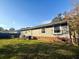 Back exterior of the home showing well-maintained lawn and mature trees at 132 Heather Dr, Summerville, SC 29486