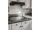 A well-lit kitchen boasts an electric stovetop and ample counter space at 132 Heather Dr, Summerville, SC 29486