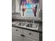 Stainless steel sink with modern faucet, granite countertops and tile backsplash at 132 Heather Dr, Summerville, SC 29486