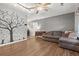The living room has hardwood floors, ceiling fan, and grey couch at 132 Heather Dr, Summerville, SC 29486