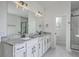 Bright bathroom with a double sink vanity, granite countertop, and matte black fixtures at 136 Mitch Ln, Holly Hill, SC 29059
