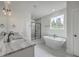 Bathroom featuring double sinks, a soaking tub, and a glass-enclosed shower at 136 Mitch Ln, Holly Hill, SC 29059