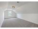 Bonus room featuring carpet, neutral walls, a window letting in natural light, and a light fixture at 136 Mitch Ln, Holly Hill, SC 29059