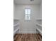Walk-in closet featuring hardwood floors and bright white shelving at 136 Mitch Ln, Holly Hill, SC 29059