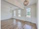 Open dining area featuring hardwood floors, modern lighting, and large windows with natural light at 136 Mitch Ln, Holly Hill, SC 29059