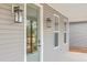 Close-up view of front entrance with a green door, sidelight, and modern exterior lighting at 136 Mitch Ln, Holly Hill, SC 29059