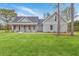 Attractive gray home with a covered front porch and lush green lawn on a bright day at 136 Mitch Ln, Holly Hill, SC 29059