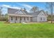 Charming gray home with a covered front porch and beautifully manicured lawn on a sunny day at 136 Mitch Ln, Holly Hill, SC 29059