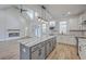 Open kitchen/living room featuring an island, stainless appliances, and a cozy fireplace at 136 Mitch Ln, Holly Hill, SC 29059