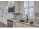 Bright kitchen featuring stainless steel appliances, granite countertops, and a large sink at 136 Mitch Ln, Holly Hill, SC 29059