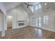 Bright living room featuring vaulted ceilings, hardwood floors, and a modern fireplace at 136 Mitch Ln, Holly Hill, SC 29059