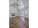Open living room boasts vaulted ceilings, a modern fireplace, and french doors at 136 Mitch Ln, Holly Hill, SC 29059