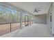 Covered porch with screened windows, neutral walls, and ceiling fan at 136 Mitch Ln, Holly Hill, SC 29059