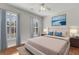 Serene bedroom with hardwood floors, soft blue accents, plantation shutters, and natural light at 1362 Kingsford Ln, Mount Pleasant, SC 29466