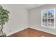 Bright bedroom featuring light walls, laminate wood flooring, and a large window with shutter style blinds at 1362 Kingsford Ln, Mount Pleasant, SC 29466
