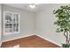 Bright bedroom featuring light walls, laminate wood flooring, and a large window with shutter style blinds at 1362 Kingsford Ln, Mount Pleasant, SC 29466