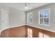 Spacious bedroom with hardwood floors, neutral walls, and natural light through plantation shutters at 1362 Kingsford Ln, Mount Pleasant, SC 29466