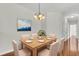Cozy dining room with wood table, chandelier, and a view into the hallway at 1362 Kingsford Ln, Mount Pleasant, SC 29466