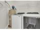 Bright laundry room features washer, dryer, shelving, and water heater at 1362 Kingsford Ln, Mount Pleasant, SC 29466