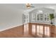 Spacious living room with hardwood floors, vaulted ceilings, modern fan, and plantation shutters, providing elegance at 1362 Kingsford Ln, Mount Pleasant, SC 29466