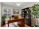 Inviting home office with hardwood floors, a large desk, and natural light from the window at 1362 Kingsford Ln, Mount Pleasant, SC 29466