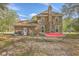 Exterior view of brick home with patio and lawn space, providing a glimpse of the outdoor living area at 140 Wampee Curve, Summerville, SC 29485