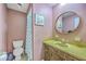Retro bathroom featuring a vanity with round mirror and toilet, showcasing a vintage style at 140 Wampee Curve, Summerville, SC 29485