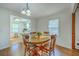 Bright dining room with wood table and chairs adjacent to the kitchen at 140 Wampee Curve, Summerville, SC 29485