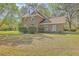 Brick home with a classic design, enhanced by lush landscaping and a well-maintained front lawn at 140 Wampee Curve, Summerville, SC 29485