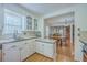 Bright kitchen with white cabinetry offering a view into the dining room at 140 Wampee Curve, Summerville, SC 29485