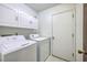 Dedicated laundry room with a washer, dryer, and storage cabinets at 140 Wampee Curve, Summerville, SC 29485