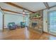Cozy living room featuring a brick fireplace, wood beams, and hardwood floors at 140 Wampee Curve, Summerville, SC 29485
