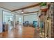 Spacious living room with hardwood floors, brick fireplace, and ceiling fan at 140 Wampee Curve, Summerville, SC 29485