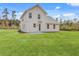 Spacious backyard with lush green grass and a charming neutral colored two-story home at 153 Mitch Ln, Holly Hill, SC 29059