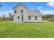 Expansive backyard featuring a well-maintained lawn and a neutral colored two-story home at 153 Mitch Ln, Holly Hill, SC 29059
