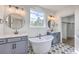 Luxurious bathroom featuring dual vanities, a freestanding tub, and attractive tile flooring at 153 Mitch Ln, Holly Hill, SC 29059