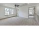 Spacious bedroom with neutral carpet, bright windows, and adjoining doorway, offering comfortable living space at 153 Mitch Ln, Holly Hill, SC 29059