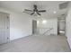 Large bedroom featuring neutral carpet, ample lighting, and easy access to stairs and other rooms at 153 Mitch Ln, Holly Hill, SC 29059