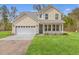 Well-maintained two-story home with a spacious lawn, two-car garage, and a driveway at 153 Mitch Ln, Holly Hill, SC 29059