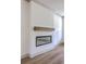 Contemporary fireplace featuring a sleek design, a wooden mantel, and hardwood floors at 153 Mitch Ln, Holly Hill, SC 29059