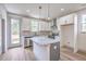 Bright, open kitchen featuring white cabinets, stainless steel appliances, and a gray kitchen island at 153 Mitch Ln, Holly Hill, SC 29059