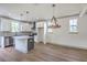 Modern kitchen with white cabinets, stainless steel appliances, an island, and hardwood floors at 153 Mitch Ln, Holly Hill, SC 29059