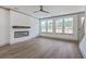 Bright living room featuring hardwood floors, a modern fireplace, and large windows at 153 Mitch Ln, Holly Hill, SC 29059