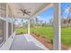 Relaxing screened porch with a ceiling fan and picturesque views of the surrounding landscape at 153 Mitch Ln, Holly Hill, SC 29059