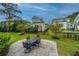 Backyard patio with an outdoor dining set, manicured lawn, and black metal fence at 1543 Watoga Way, Mount Pleasant, SC 29466