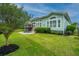 Expansive backyard with lush green lawn, a patio area and mature trees, and perimeter fencing at 1543 Watoga Way, Mount Pleasant, SC 29466