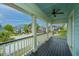 Covered outdoor balcony with a ceiling fan and views of the manicured neighborhood at 1543 Watoga Way, Mount Pleasant, SC 29466